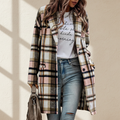 Pink plaid button up lapel jacket on a warm ivory boutique studio background