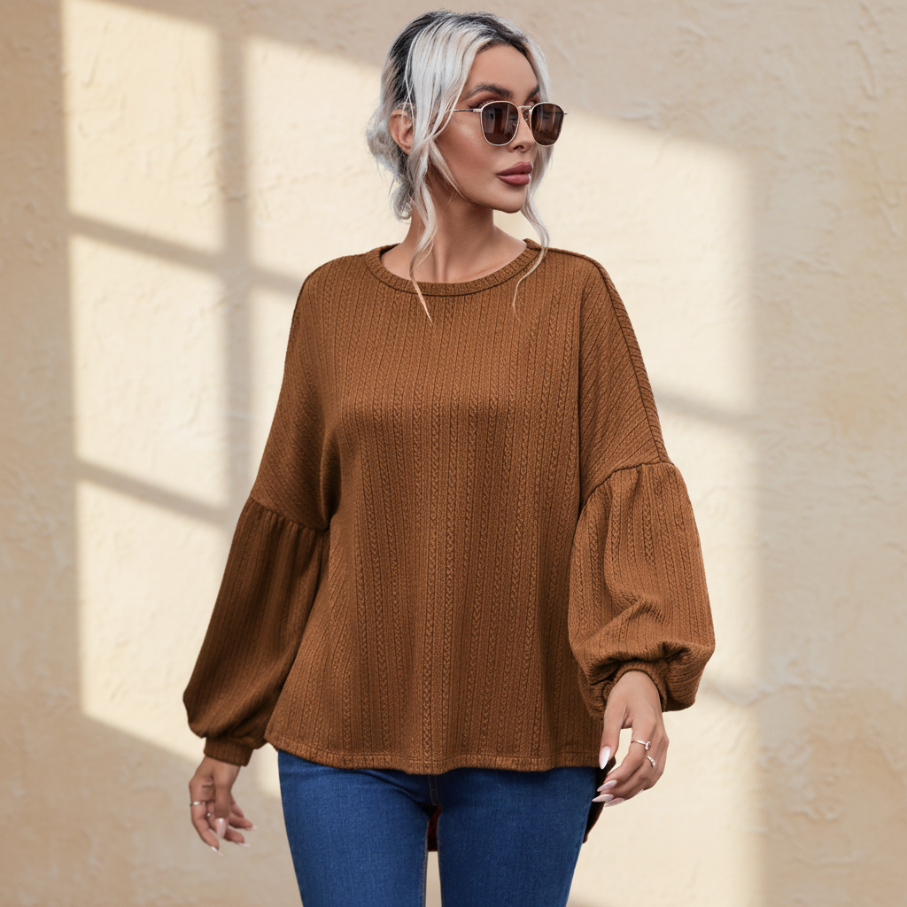 Faux knit jacquard puffy long sleeve top on a warm ivory boutique studio background