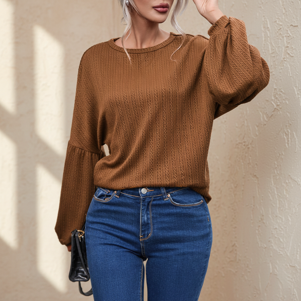 Faux knit jacquard puffy long sleeve top on a warm ivory boutique studio background