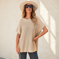 Apricot short sleeve side slit oversized sweater on a warm ivory boutique studio background