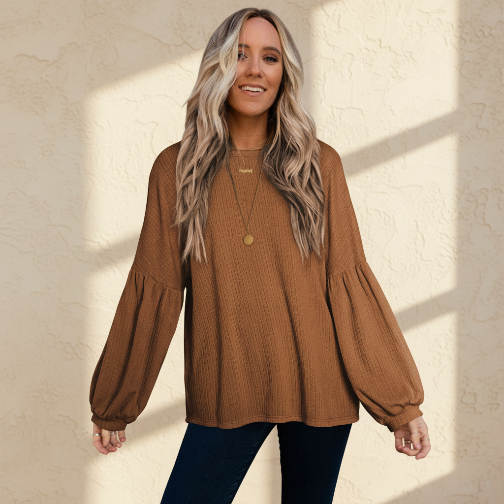 Faux knit jacquard puffy long sleeve top on a warm ivory boutique studio background