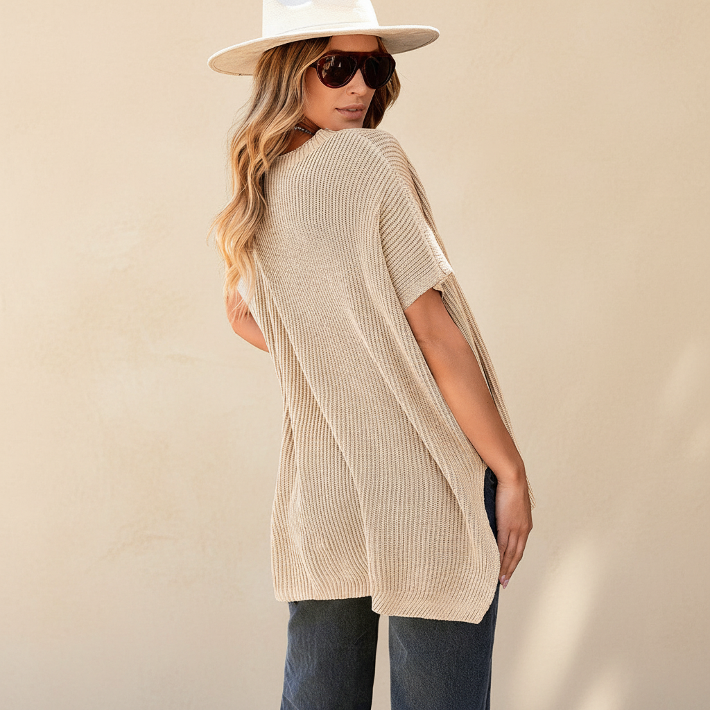 Apricot short sleeve side slit oversized sweater on a warm ivory boutique studio background