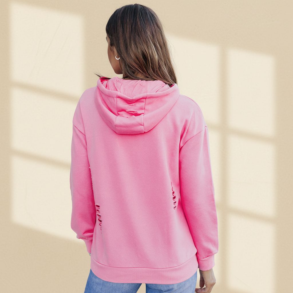 Pink solid ripped hooded sweatshirt with kangaroo pocket on a warm ivory boutique studio background