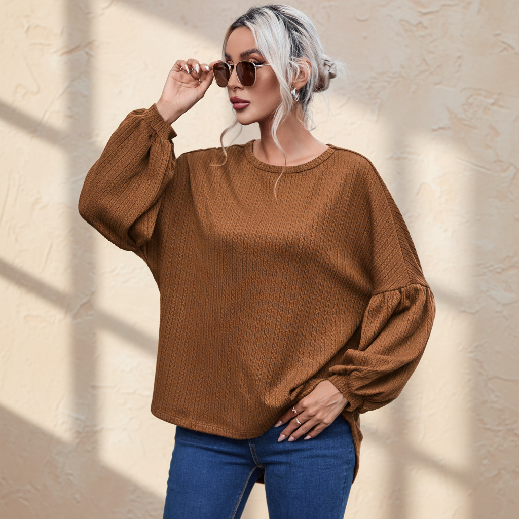 Faux knit jacquard puffy long sleeve top on a warm ivory boutique studio background
