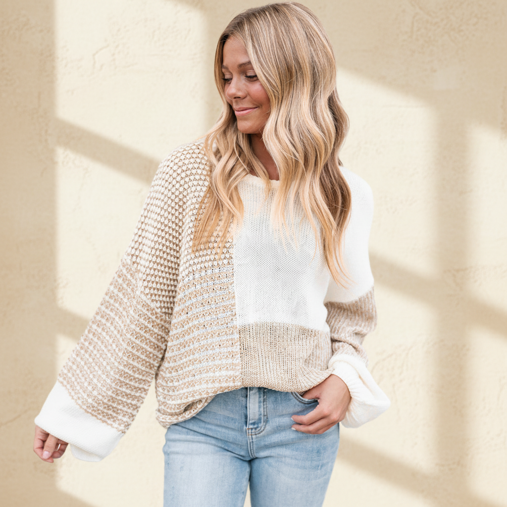 Oatmeal mixed pattern knit tie keyhole drop shoulder sweater on a warm ivory boutique studio background