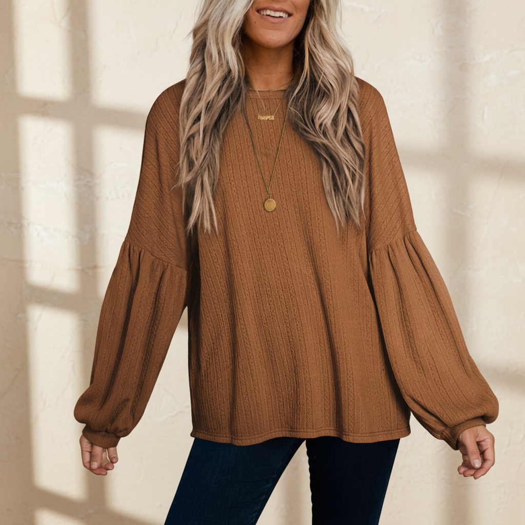 Faux knit jacquard puffy long sleeve top on a warm ivory boutique studio background