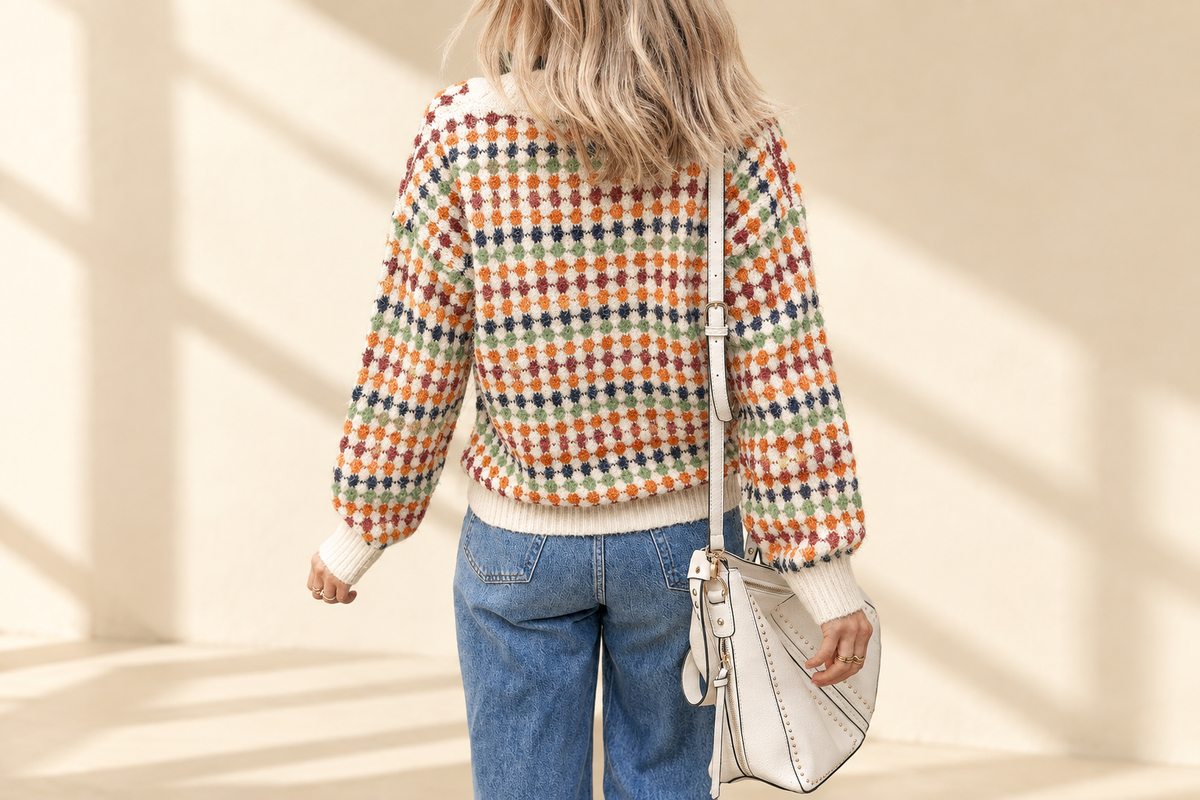 Multicolour dotty pattern knit button-front V-neck sweater cardigan on a warm ivory boutique background, angle 2