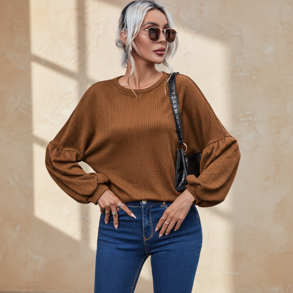 Faux knit jacquard puffy long sleeve top on a warm ivory boutique studio background