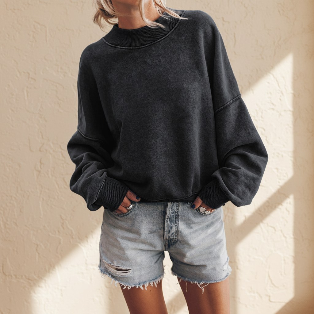 Black drop shoulder crew neck pullover sweatshirt on a warm ivory boutique studio background