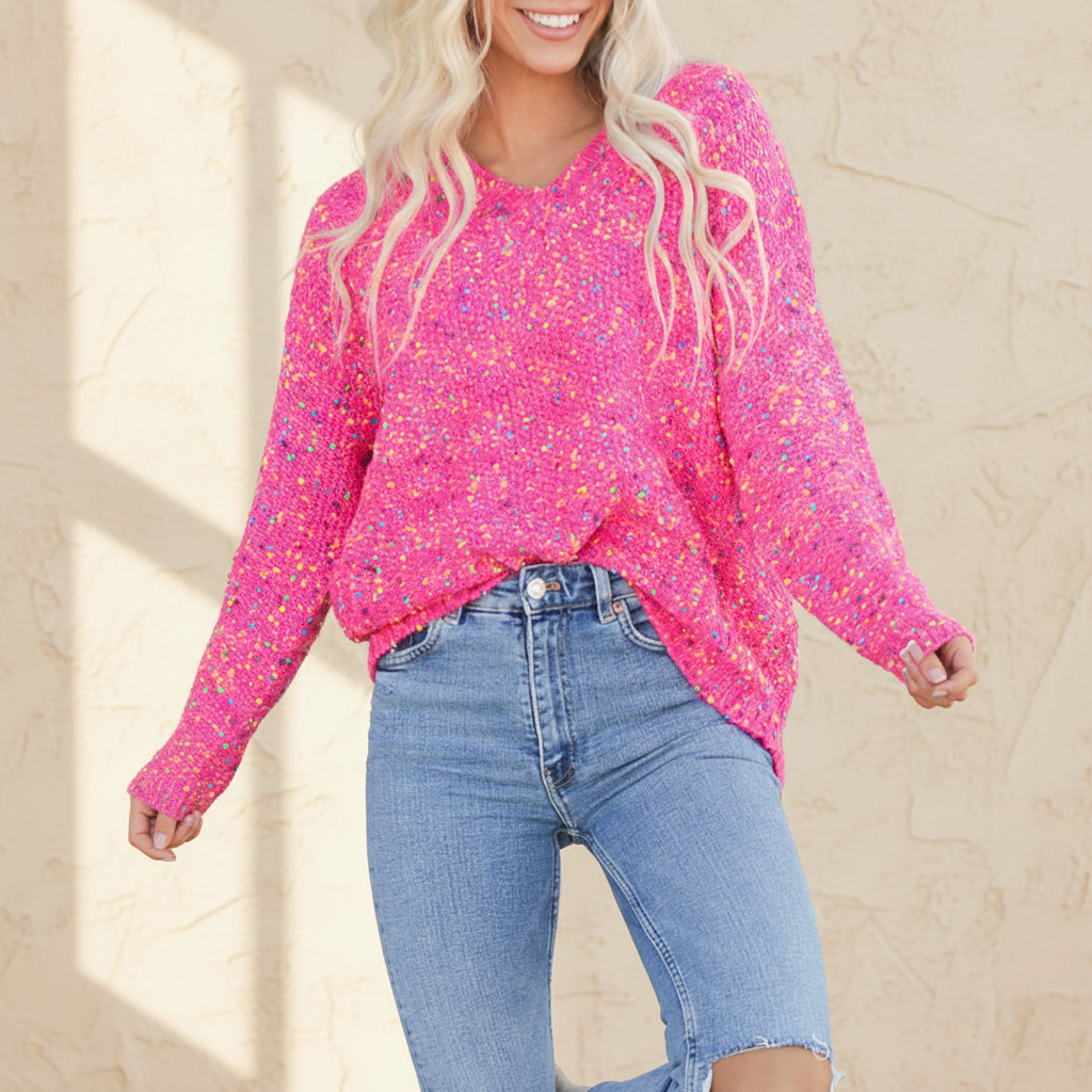 Dark pink colorful spots knitted V neck casual sweater on a warm ivory boutique studio background