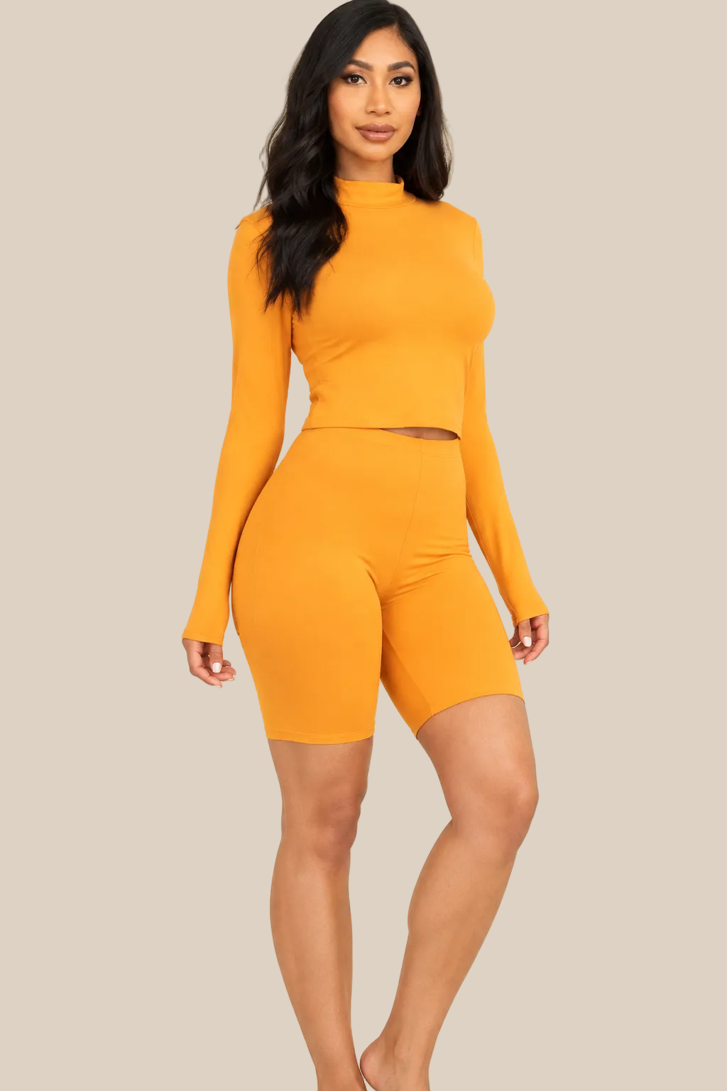Tomato Cream mock neck top and biker shorts set, three-quarter view on a warm ivory boutique background